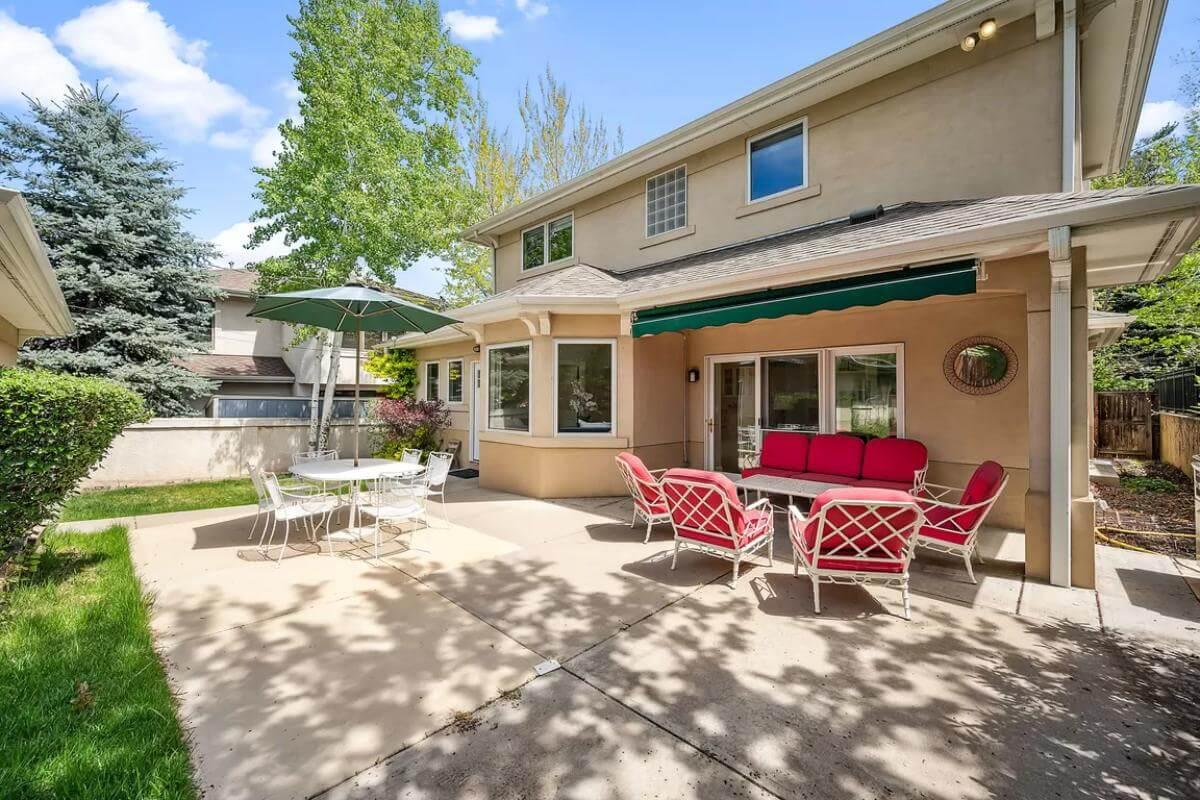Lively Patio Space with Bold Red Cushions and Green Awning