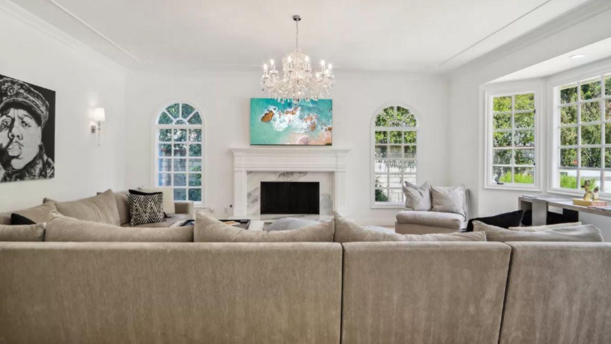 This Living Room Shines With a Crystal Chandelier and Contrasting Artwork