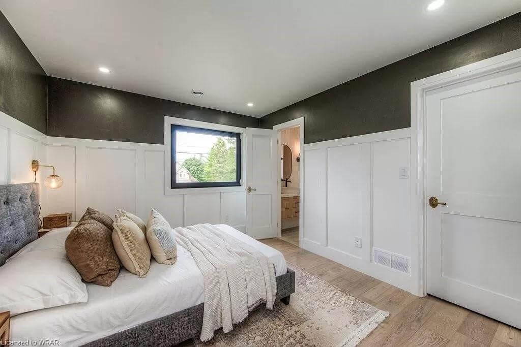 Check Out the Wainscoting and Dark Accent Walls in This Stylish Bedroom