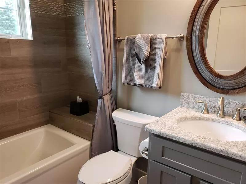 Notice the Textured Pebble Tile in This Craftsman Bathroom