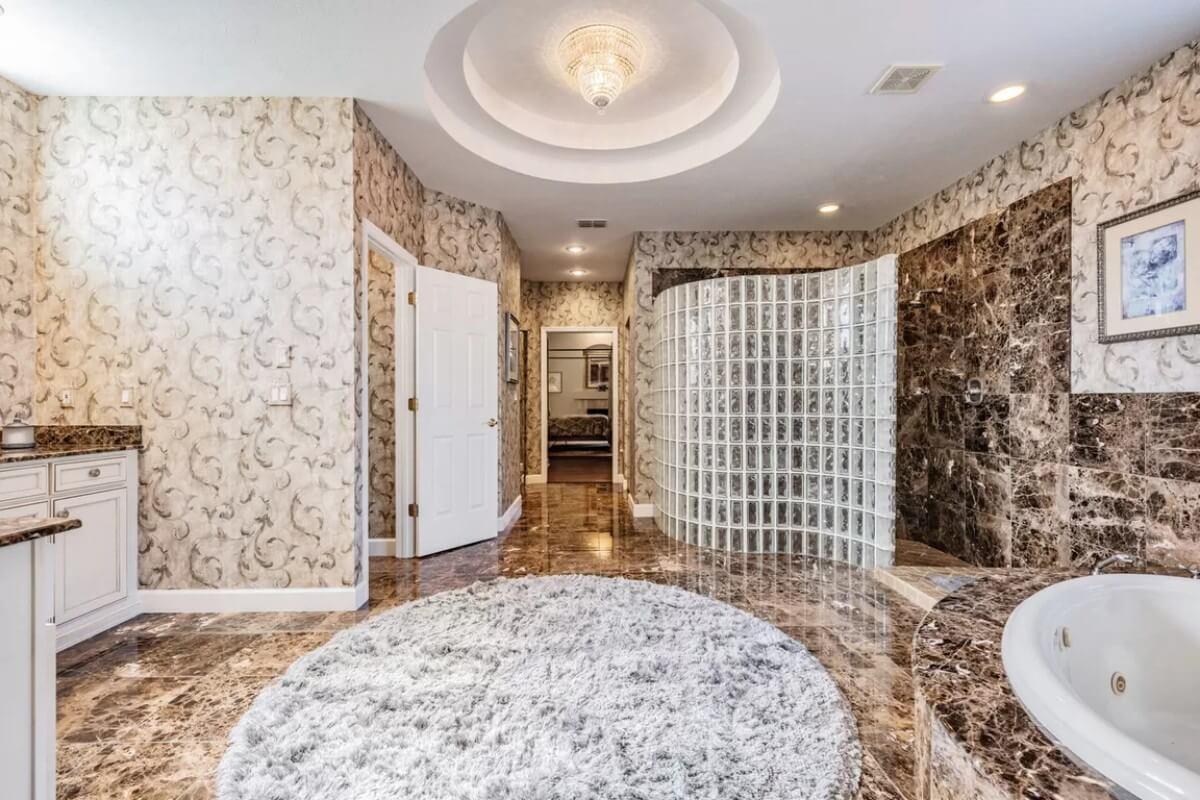 Luxurious Bathroom with Glass Block Shower and Marble Flooring