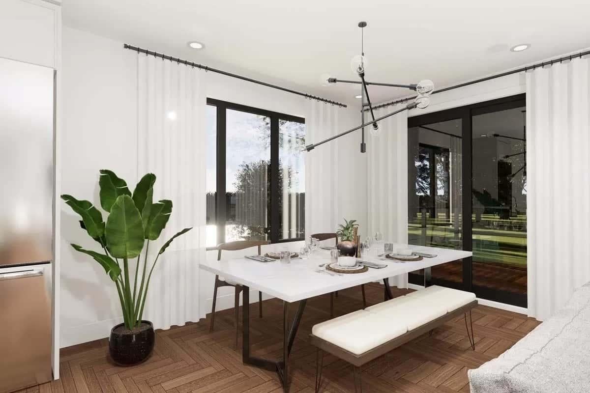 Dining Room with a Modern Light Fixture and Ample Natural Light
