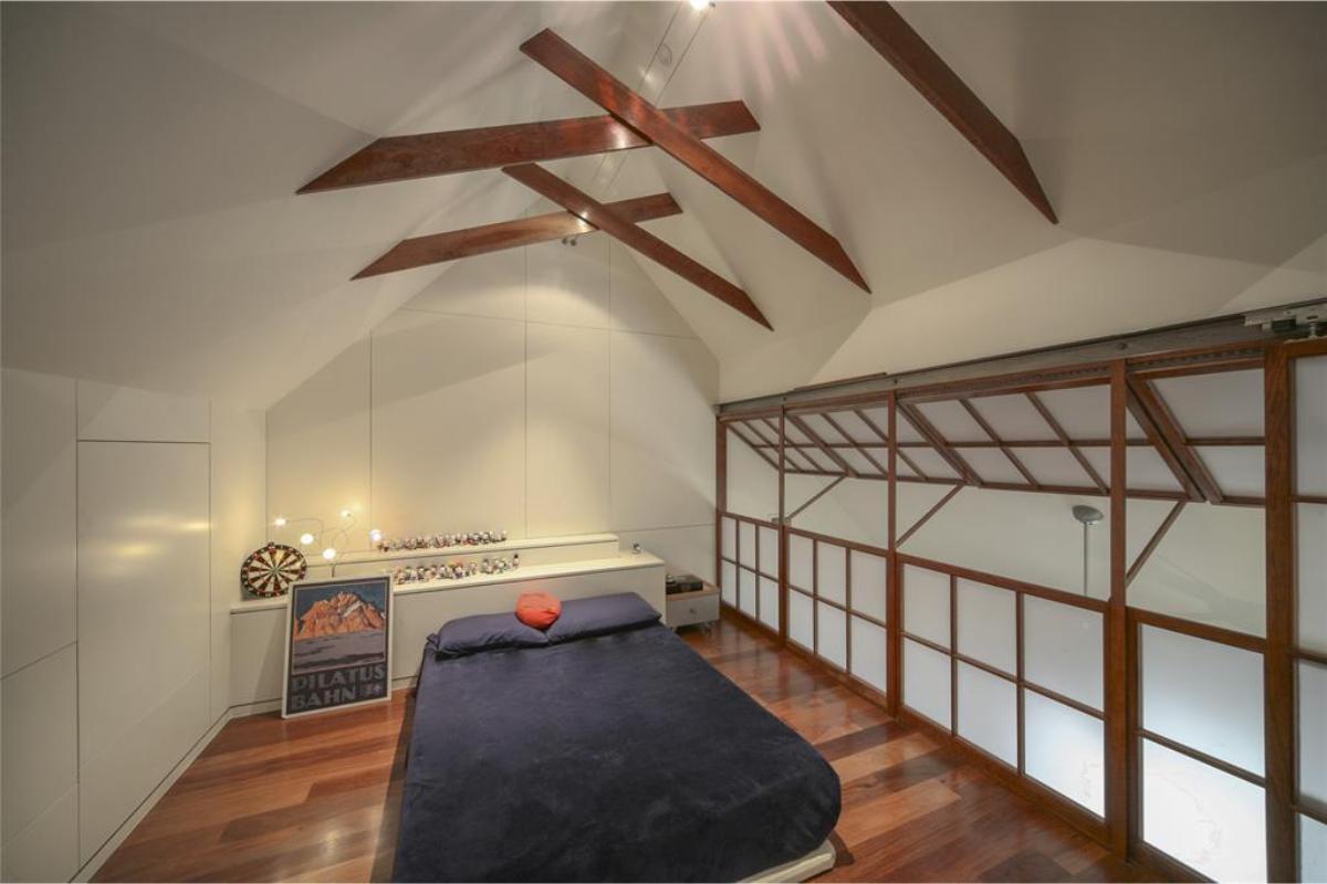 Explore the Unique Beamwork in This Contemporary Loft Bedroom