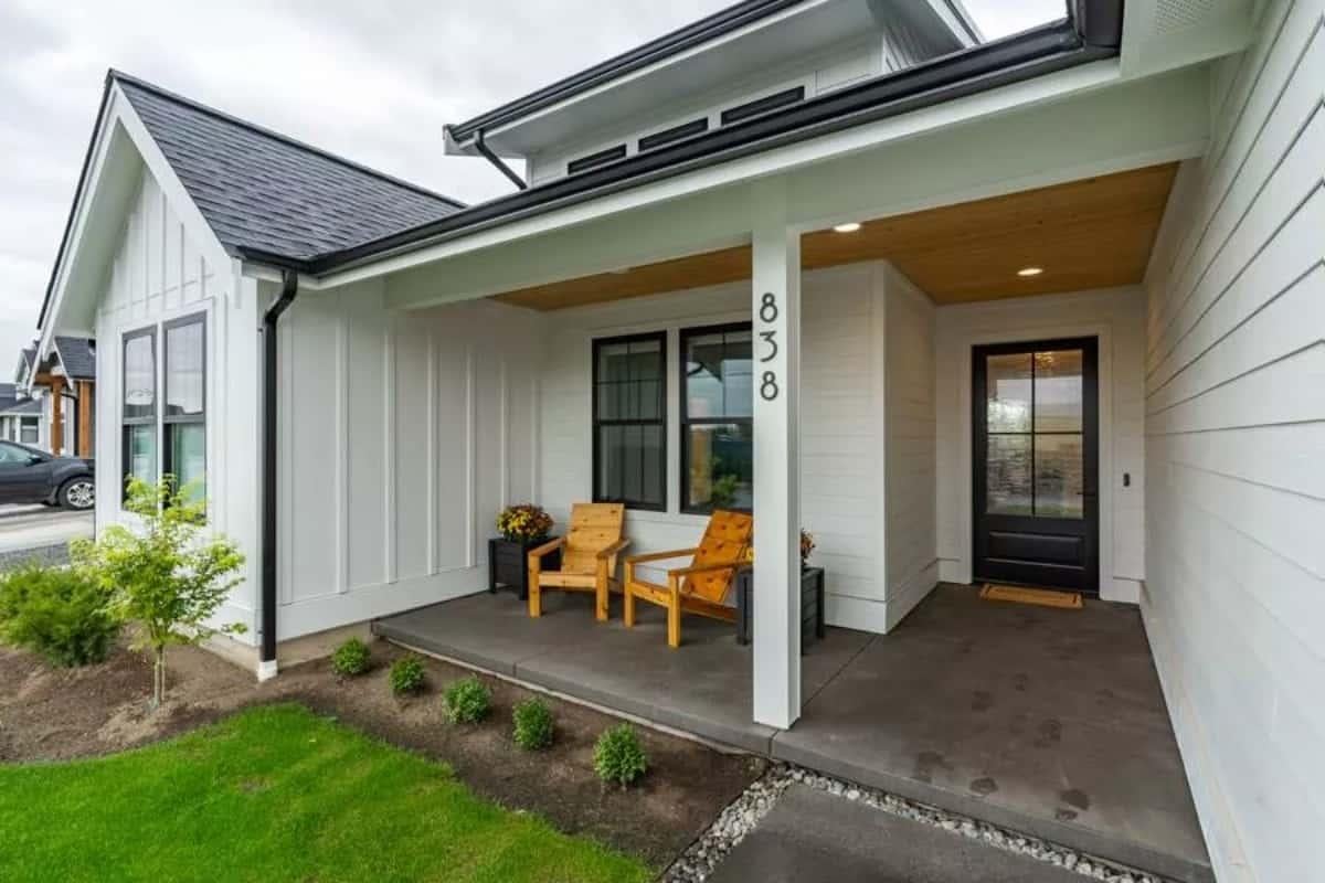 Charming Front Porch with Modern Black Door Detail