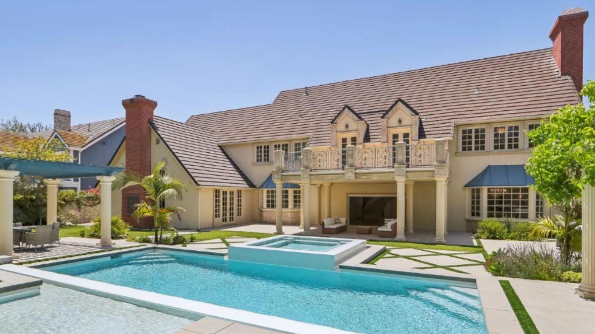 Wow, Check Out This Backyard Retreat With a Spacious Pool and Classic Columns
