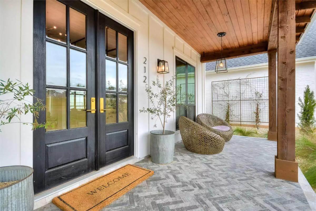 Step Onto This Farmhouse Porch with Eye-Catching Wicker Chairs