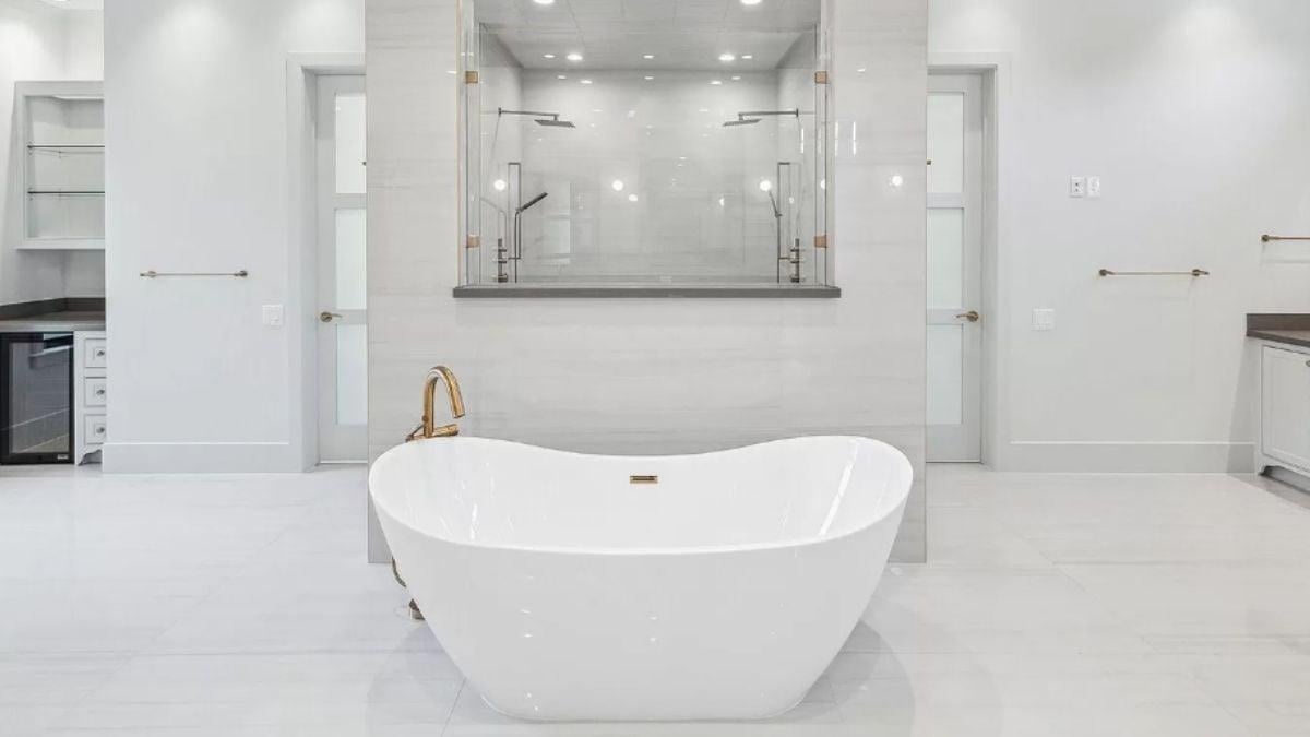 Explore the Elegant Freestanding Tub and Dual Showers in This Luxe Bathroom