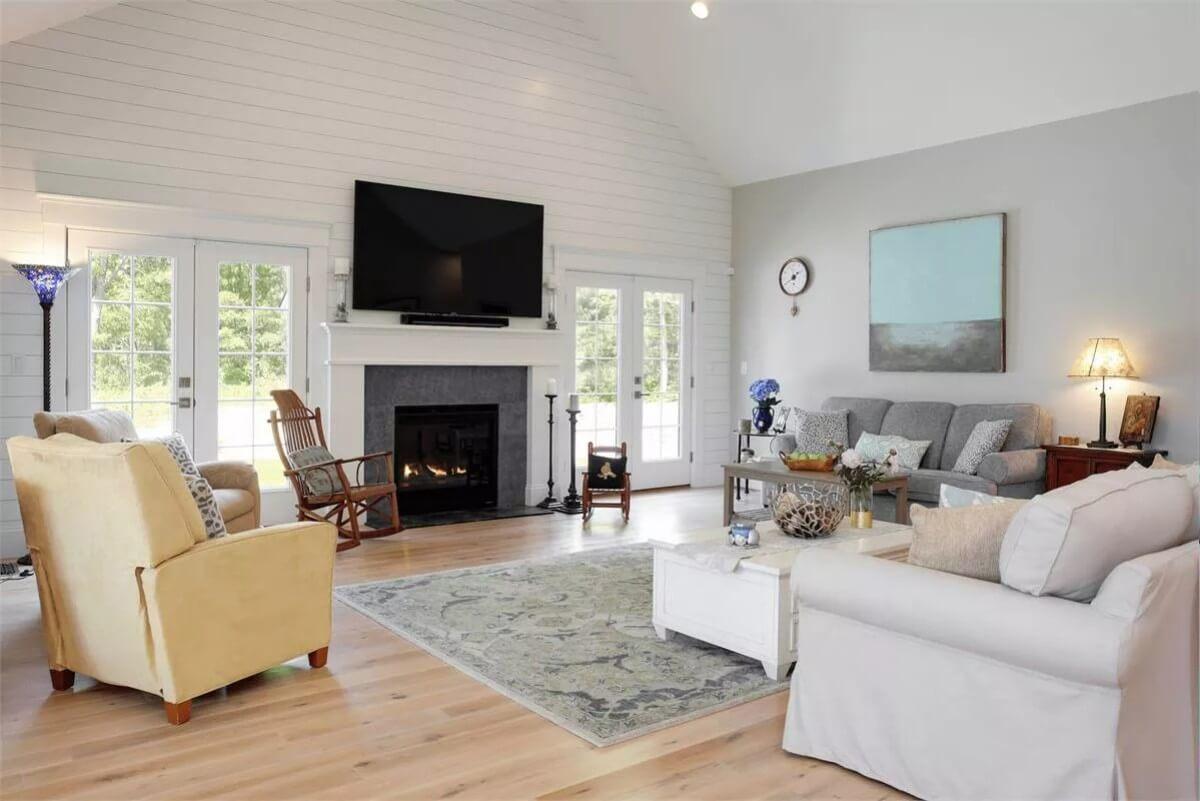 Spacious Living Room Featuring Vaulted Ceilings and Shiplap Walls