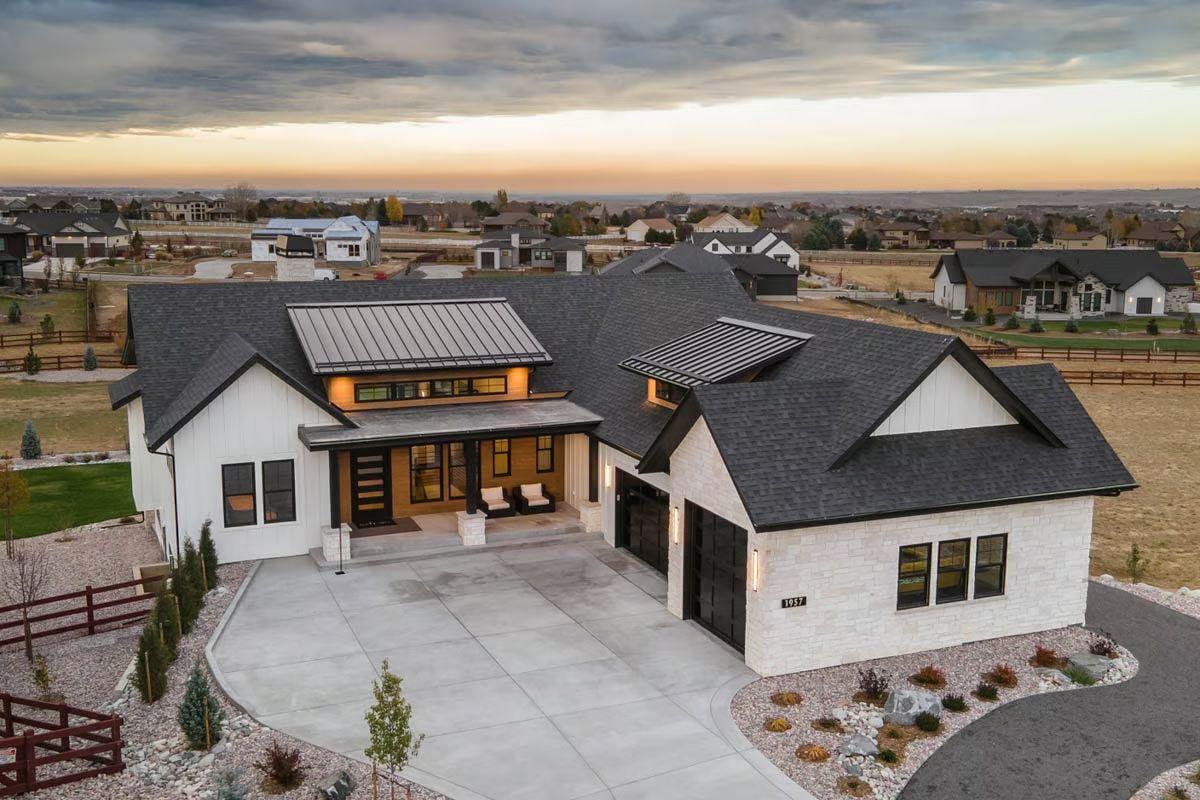 Modern Farmhouse with Striking Rooflines and Expansive Driveway