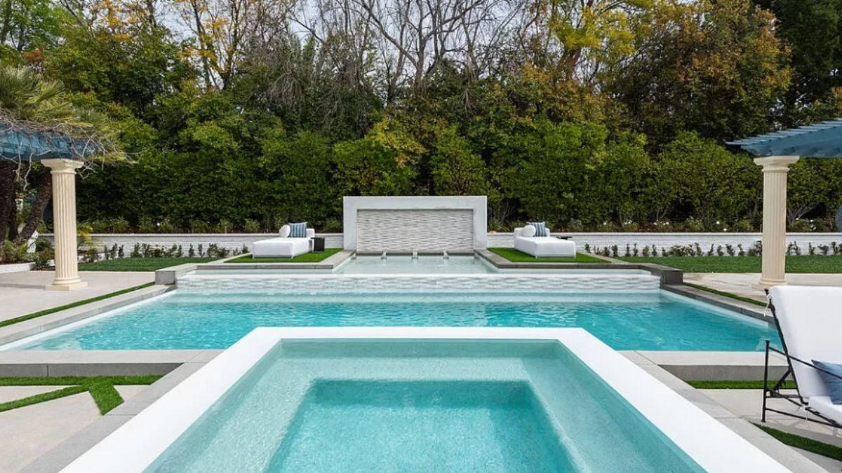 Elegant Pool Area with Tranquil Water Features and Classic Pergola