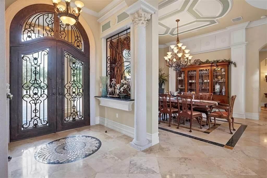 Grand Foyer with Intricate Ironwork and Elegant Dining Space