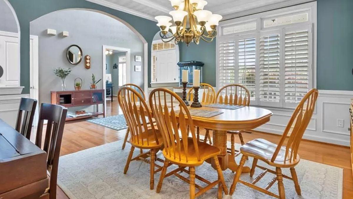 Classic Dining Room with Elegant Chandelier and Cozy Shutters