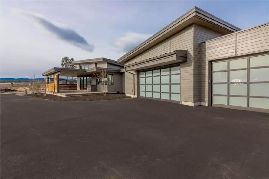 Noticing the Contemporary Lines and Frosted Glass Garage Doors