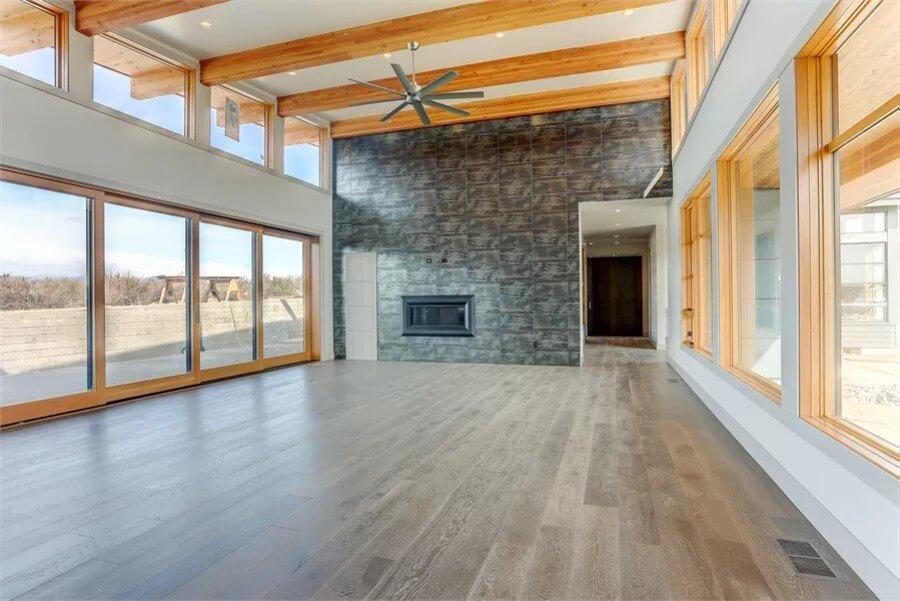 Open Living Space with Massive Stone Accent Wall and Natural Light Galore