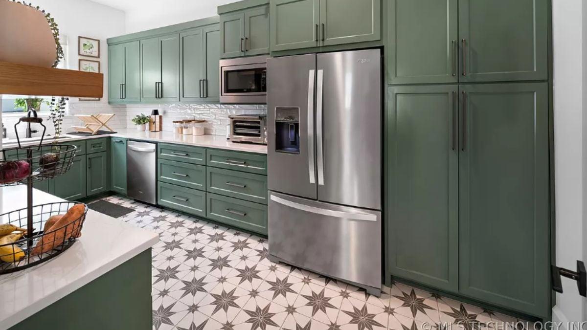 Admire the Bold Green Cabinets and Star-Patterned Floor