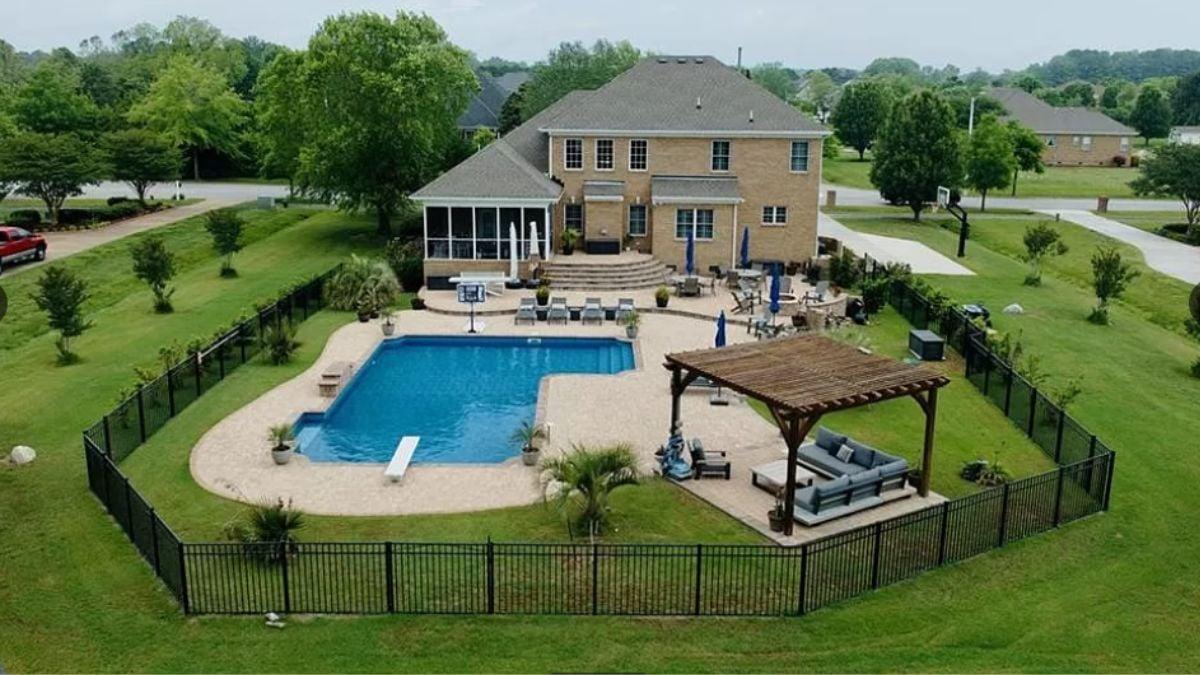 Take a Look at This Backyard Pool Oasis With a Cozy Pergola Lounge