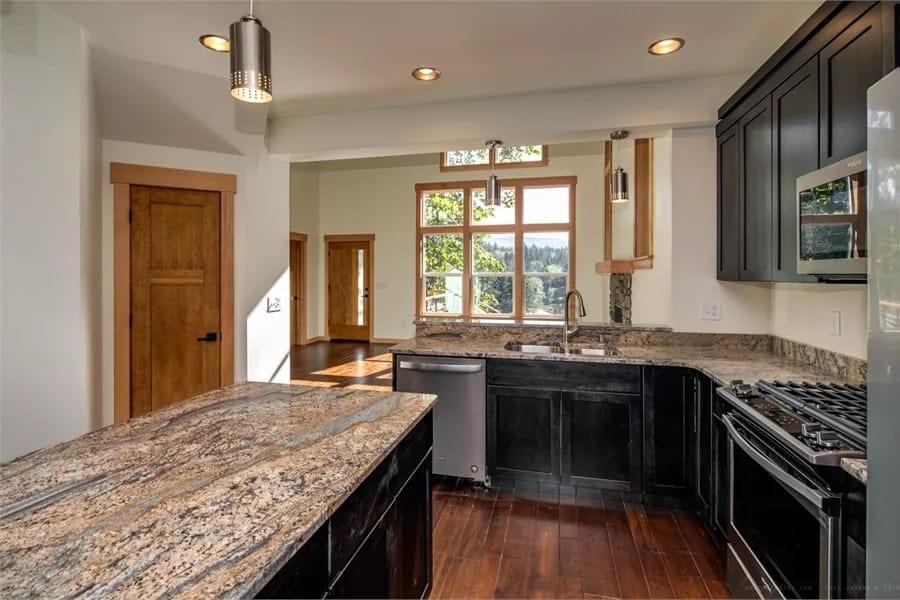 Notice the Stunning Granite Island and Bold Dark Cabinetry