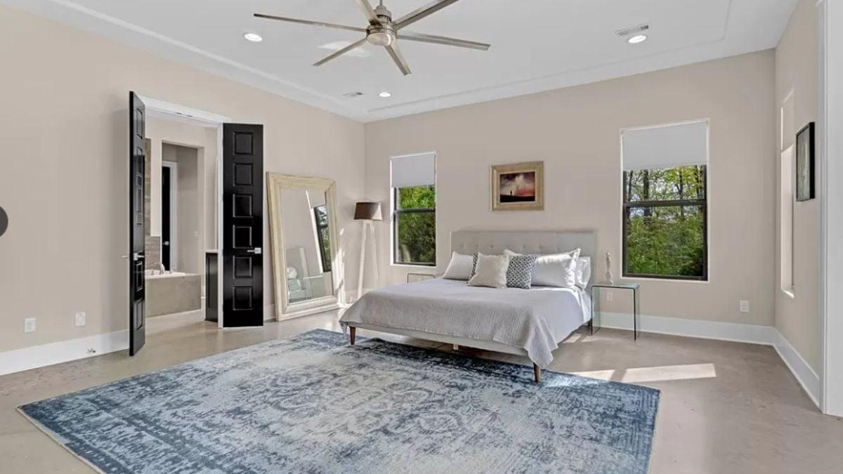 Serene Bedroom with a Modern Ceiling Fan and Statement Rug