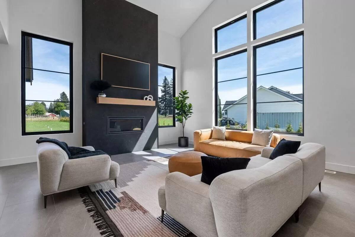 Expansive Living Room with a Striking Black Fireplace Wall
