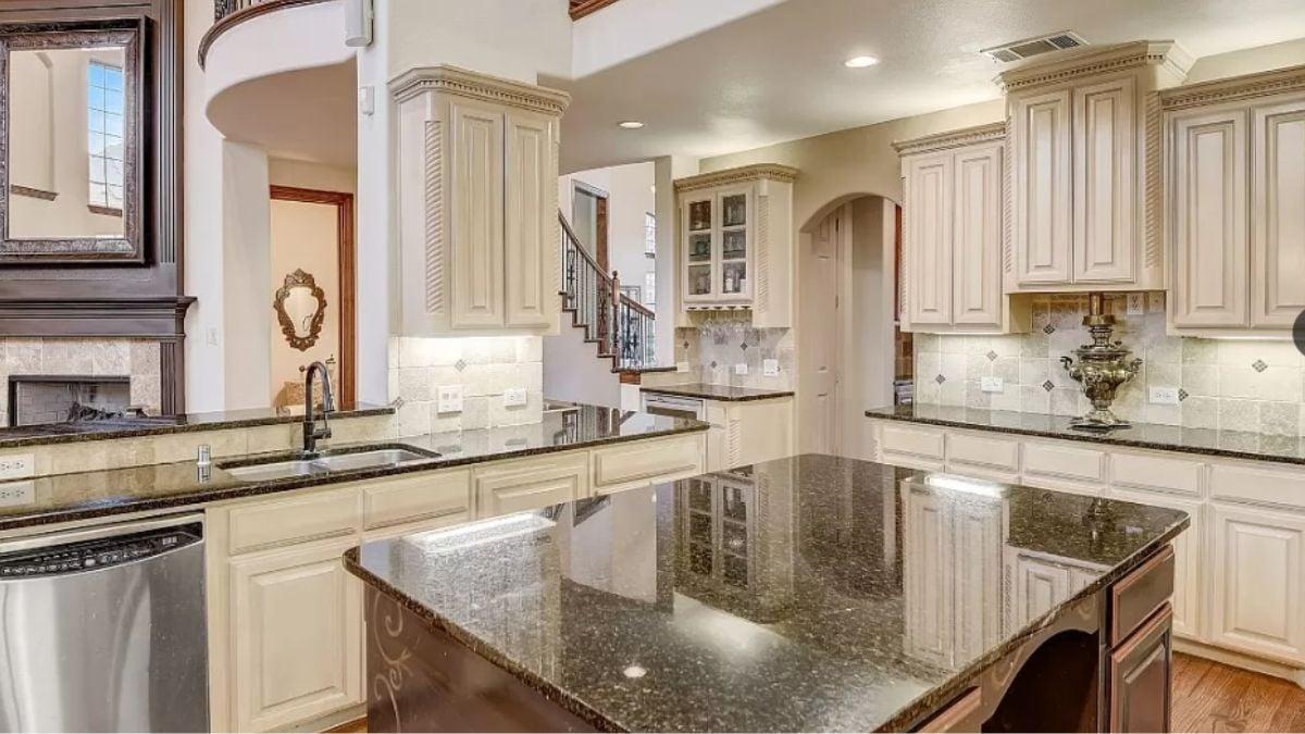 Notice the Intricate Cabinet Molding and Sleek Granite Surfaces