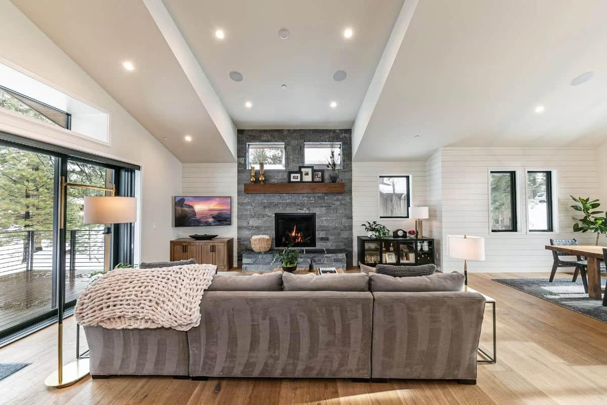 Notice the Sleek Stone Fireplace Flanked by Chic Shiplap Walls