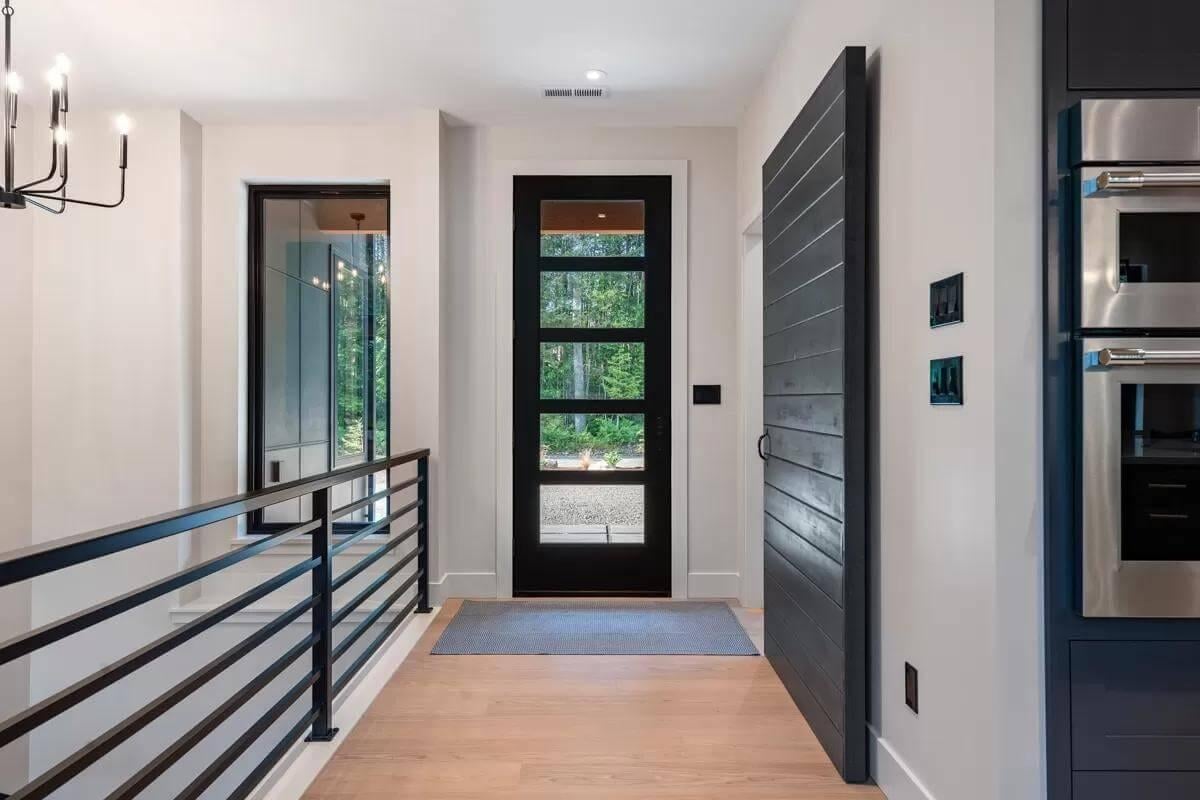 Take a Look at This Sleek Entryway with a Modern Black Door