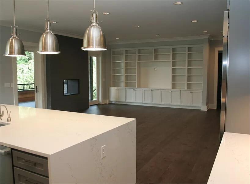 Open Living Area with Sleek Pendants and Built-in Shelving