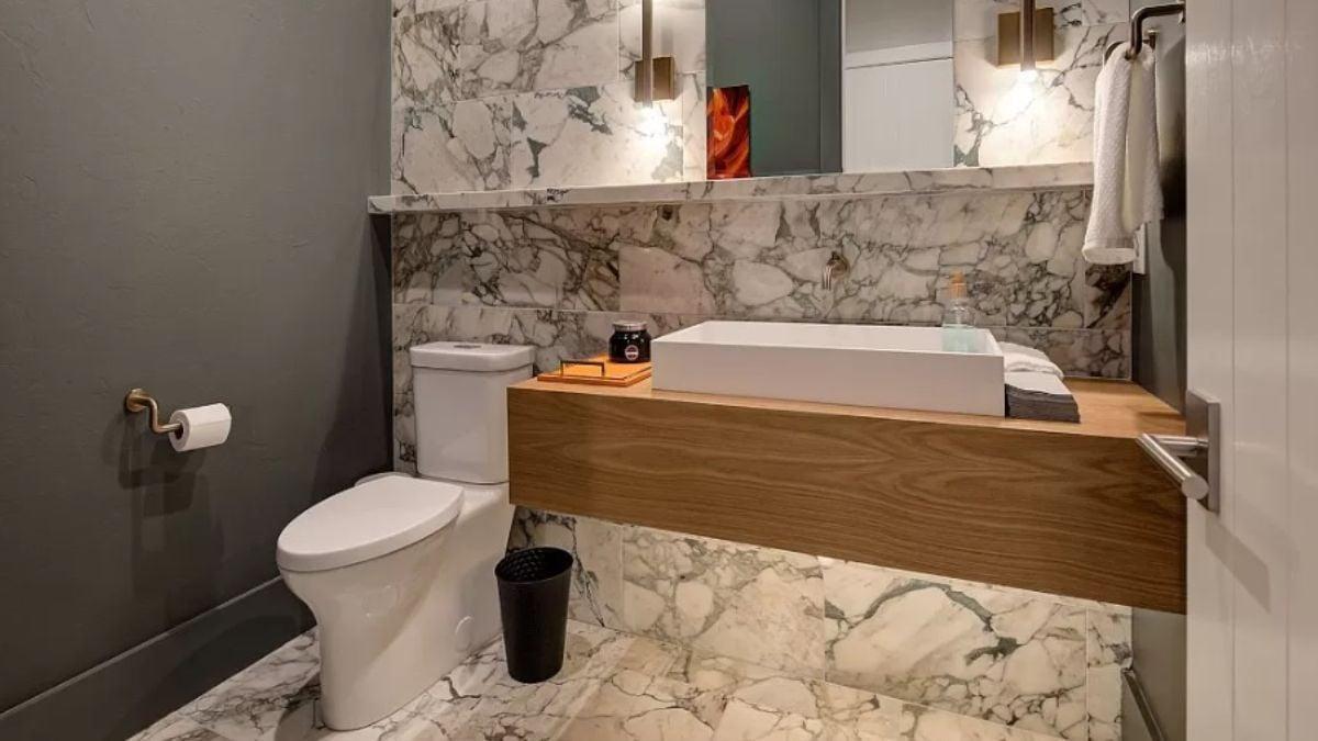 Notice the Sleek Floating Vanity and Marble Accents in This Modern Powder Room