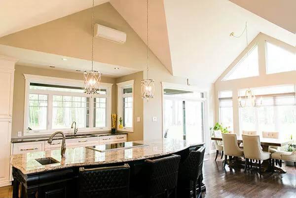 Open-Concept Kitchen and Dining With Vaulted Ceilings and Statement Lighting