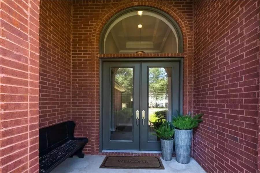 Notice the Stately Double Doors Framed by Brick