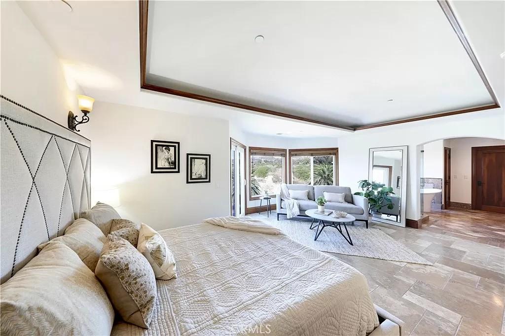 Step into This Serene Bedroom with a Cozy Sitting Area
