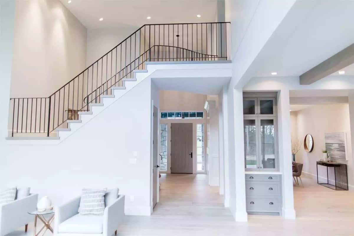 See the Sleek Iron Railing on This Staircase with High Ceilings