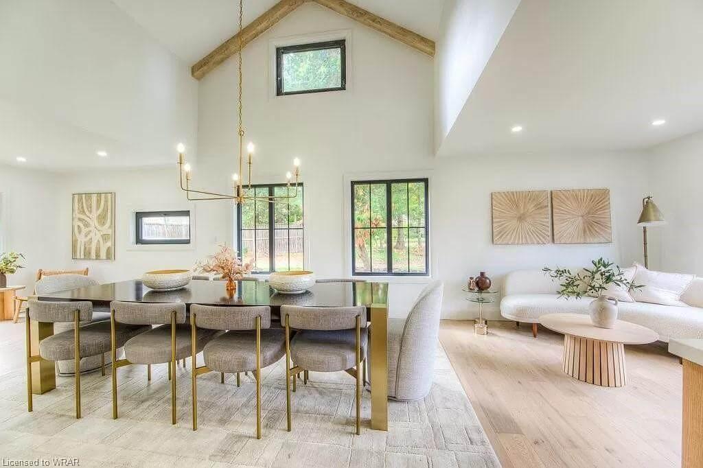 Notice the Vaulted Ceiling and Modern Chandelier in This Open Dining Space