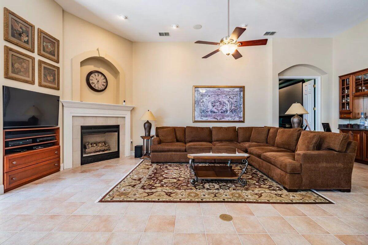 Warm Living Room with a Plush U-Shaped Sofa and Classic Fireplace