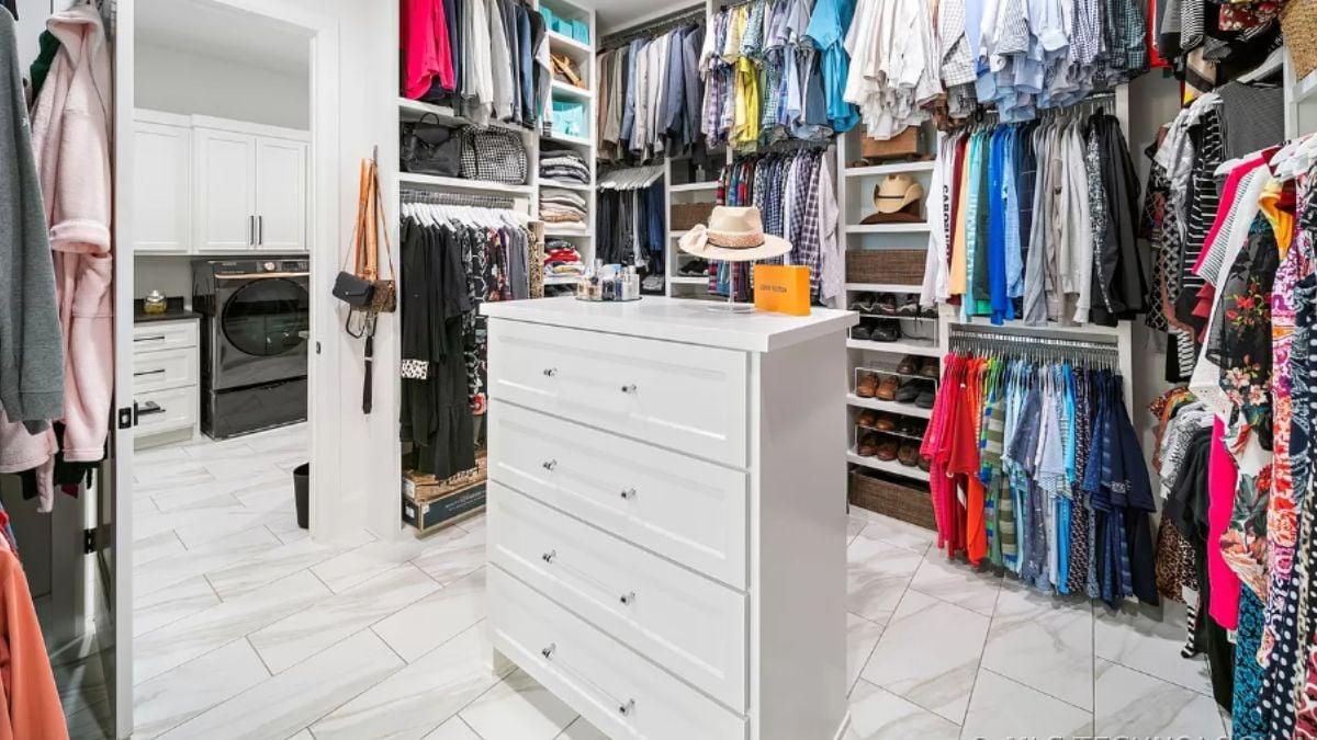 Explore This Spacious Walk-In Closet Leading to a Chic Laundry Room