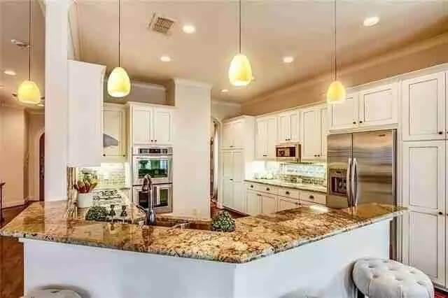 Notice the Pendant Lighting and Granite Countertops in This Expansive Kitchen