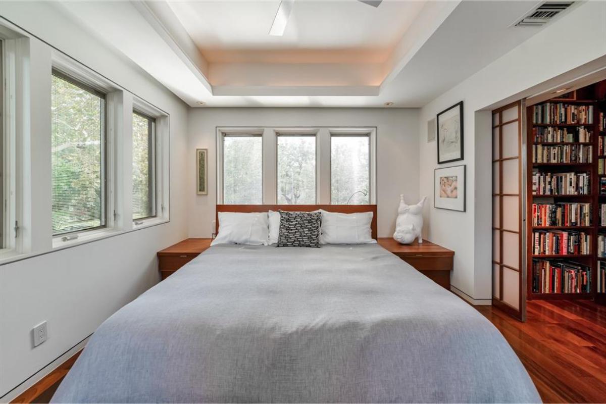 Notice How This Bedroom Connects Seamlessly to a Personal Library