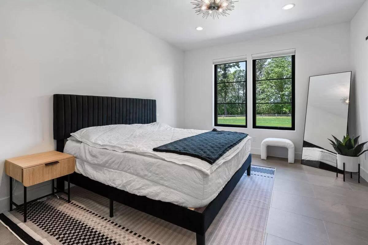 Sleek Bedroom with Black Accents and a Statement Mirror
