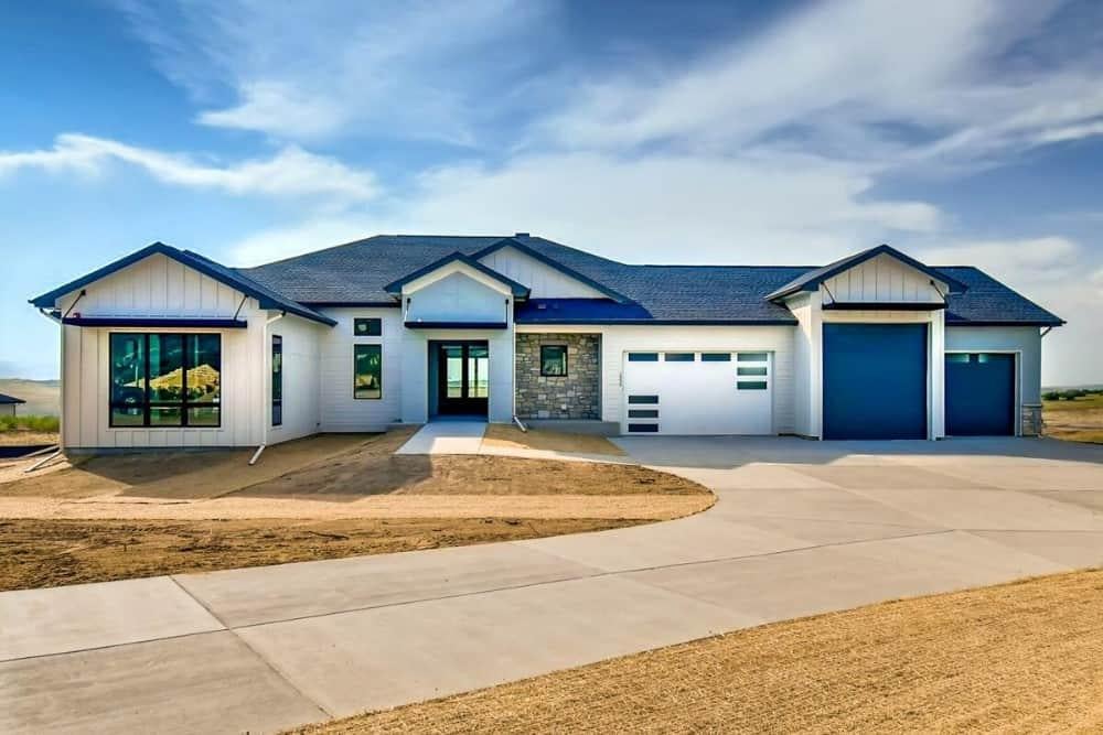 Modern Farmhouse with Striking Blue Accents and Stone Facade