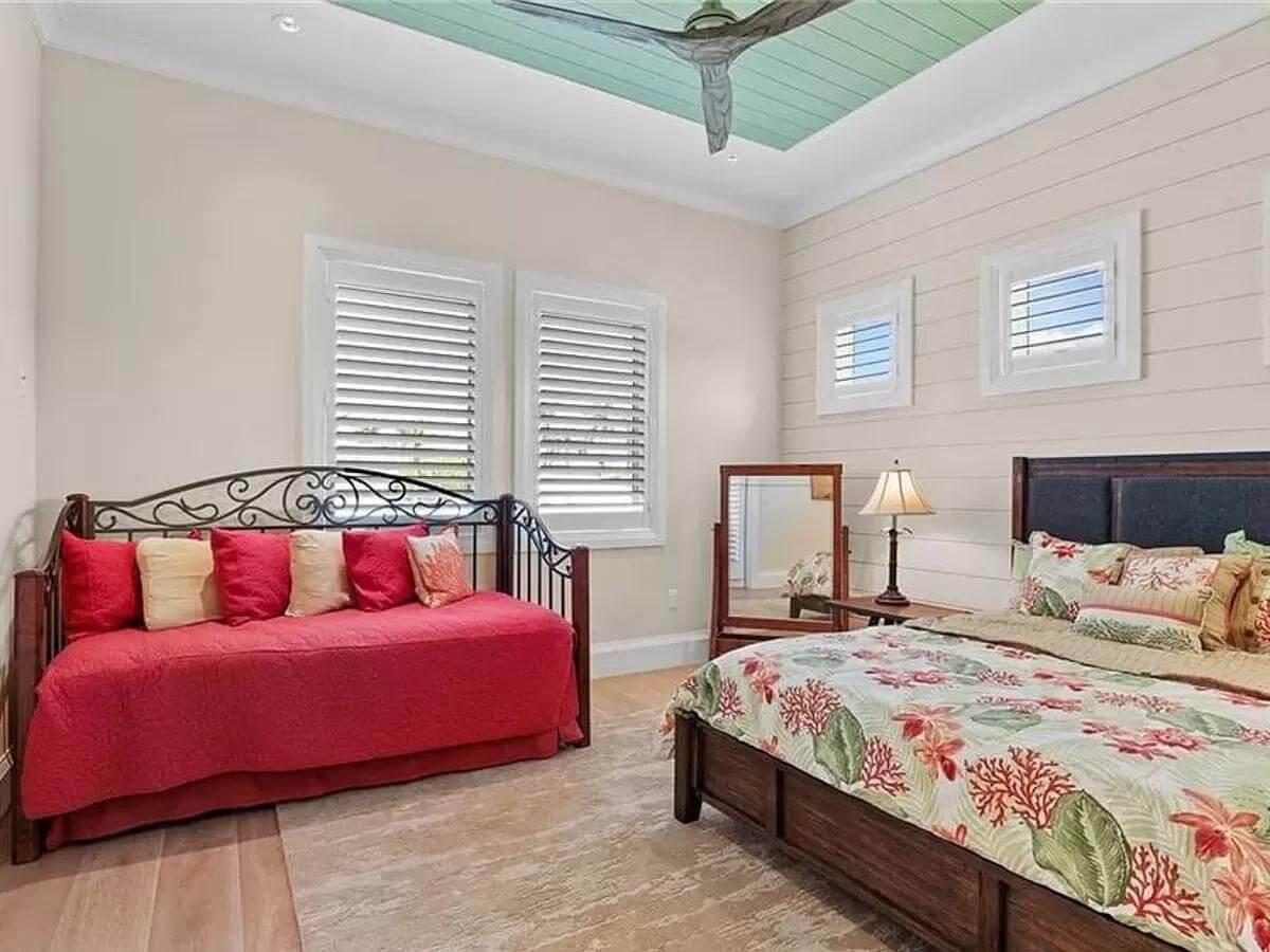 Explore the Shiplap Walls and Tropical Bedding in This Bright Bedroom