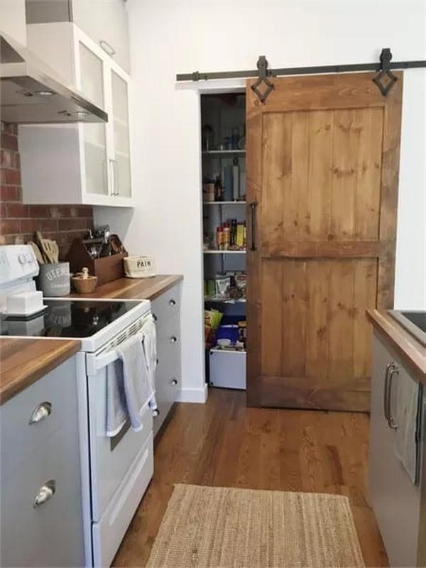 Rustic Barn Door Hides a Secret Pantry in This Charming Kitchen