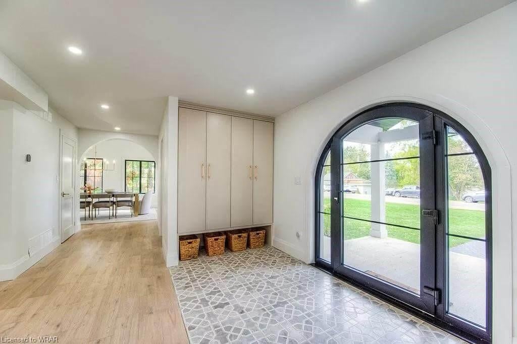 Stunning Entryway with Arched Door Framing the View Outside