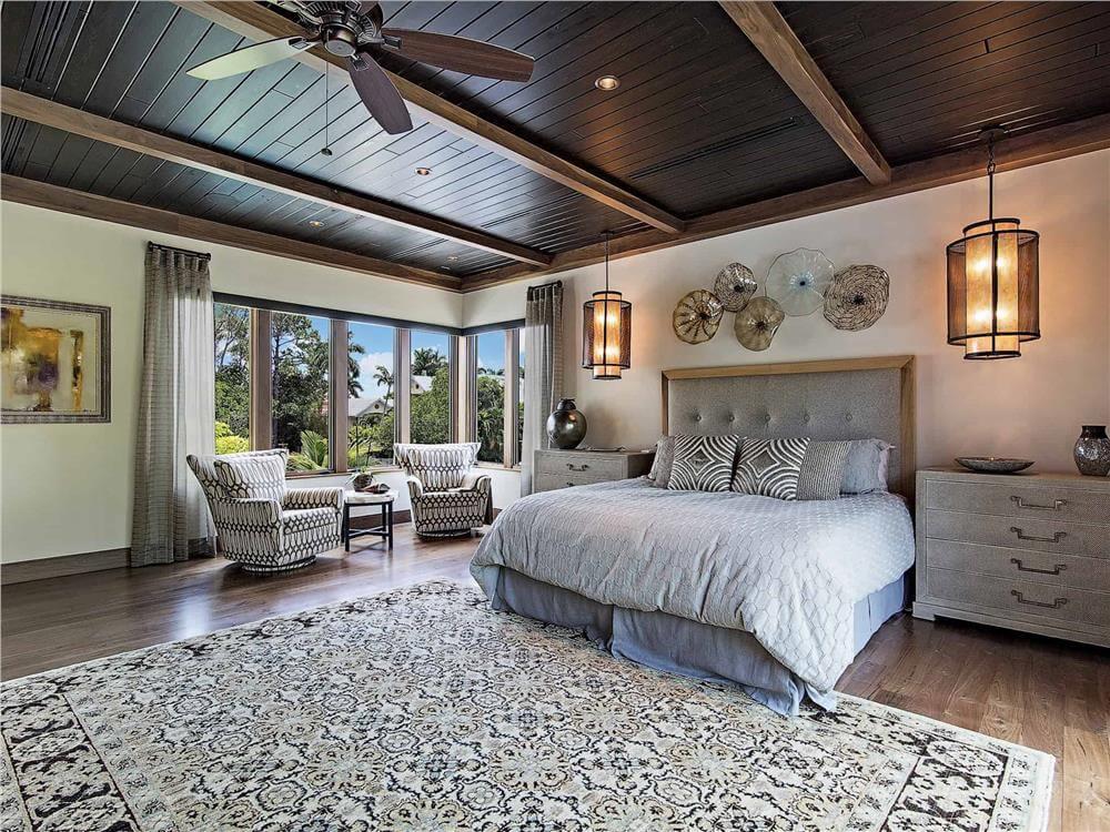Experience Relaxation with a Captivating Wooden Ceiling in This Master Suite