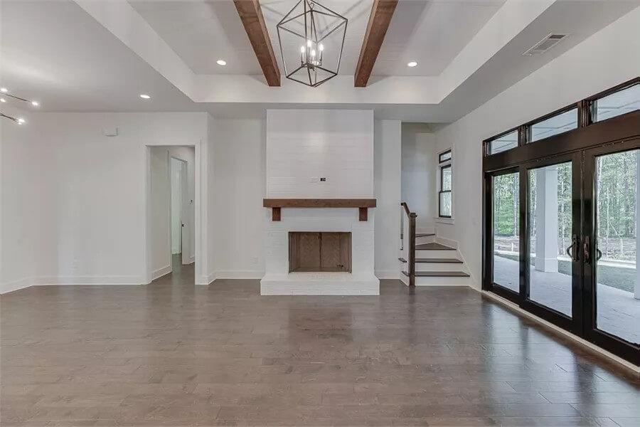 Living Room with Striking Beams and Inviting Fireplace