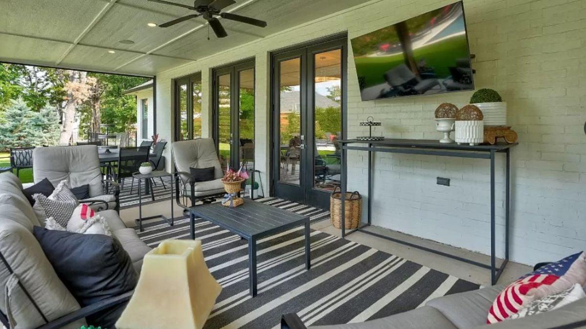 Check Out This Relaxed Patio with a TV and Striped Rug