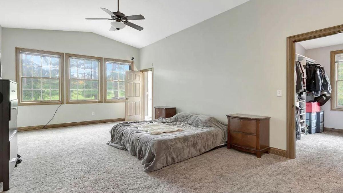 Spacious Bedroom with a View and Inviting Carpeting
