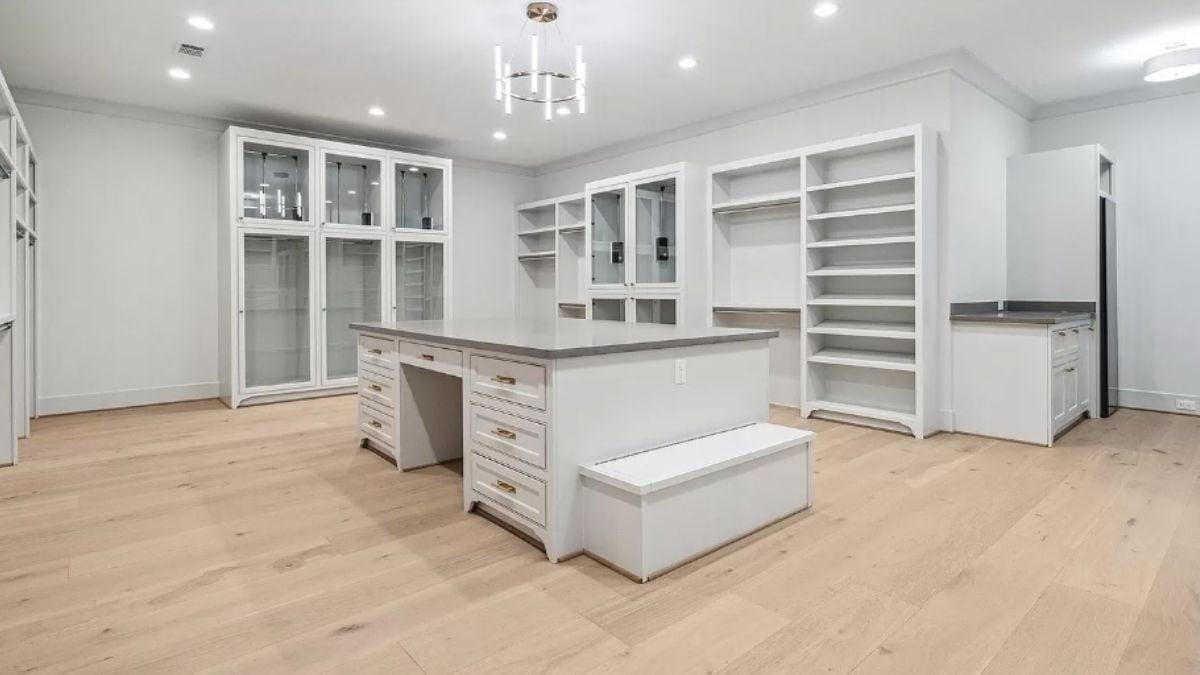 Explore the Luxurious Space in This Walk-In Closet With Island Storage