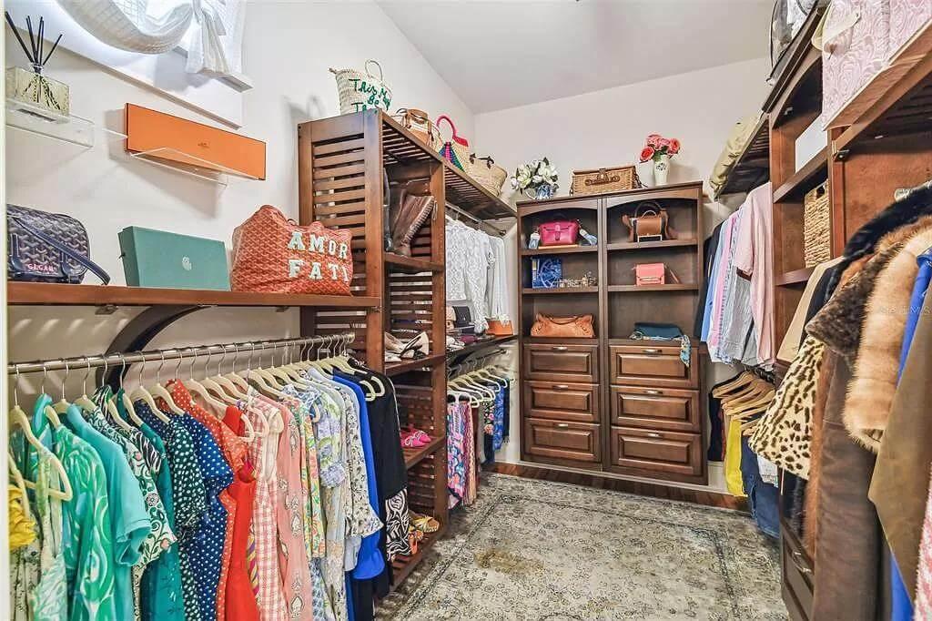 Organized Elegance in This Walk-In Closet with Rich Wooden Shelving