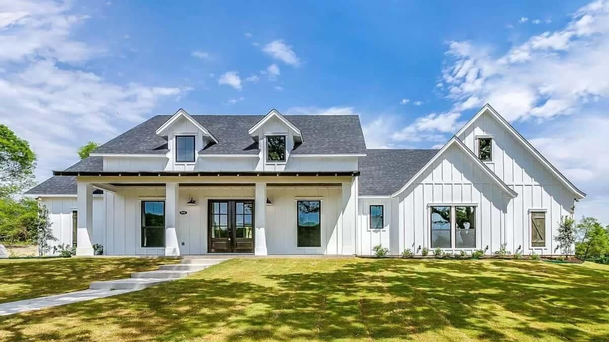 Charming Farmhouse Exterior with Dormer Windows and Elegant Board-and-Batten Siding
