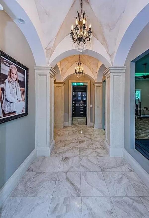 Grand Hallway with Vaulted Ceilings and Elegant Chandeliers
